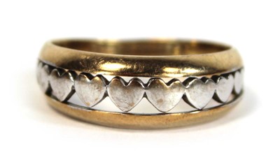 Lot 650 - A two colour metal tapered band ring decorated...