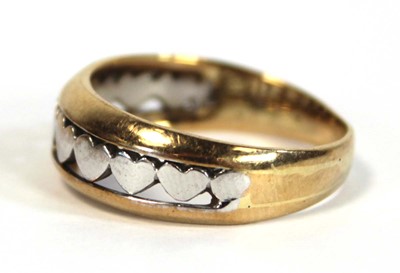 Lot 650 - A two colour metal tapered band ring decorated...