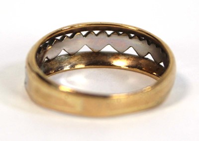 Lot 650 - A two colour metal tapered band ring decorated...