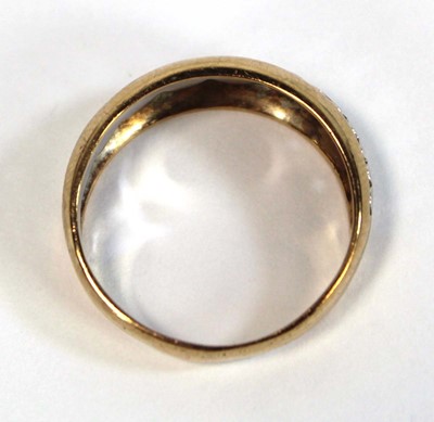 Lot 650 - A two colour metal tapered band ring decorated...