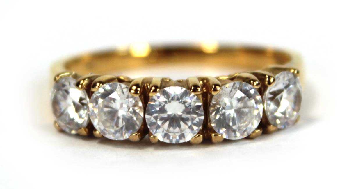 Lot 651 - A yellow metal ring set five white stones in...