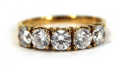 Lot 651 - A yellow metal ring set five white stones in...