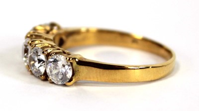 Lot 651 - A yellow metal ring set five white stones in...