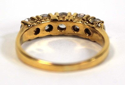Lot 651 - A yellow metal ring set five white stones in...