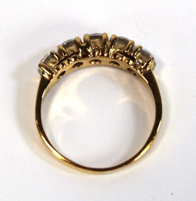 Lot 651 - A yellow metal ring set five white stones in...