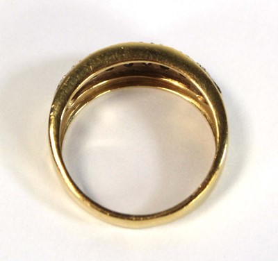 Lot 652 - A yellow metal ring set small white stones in...