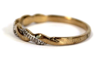 Lot 654 - A 9ct two colour gold twist type band ring set...
