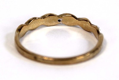 Lot 654 - A 9ct two colour gold twist type band ring set...