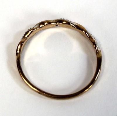 Lot 654 - A 9ct two colour gold twist type band ring set...