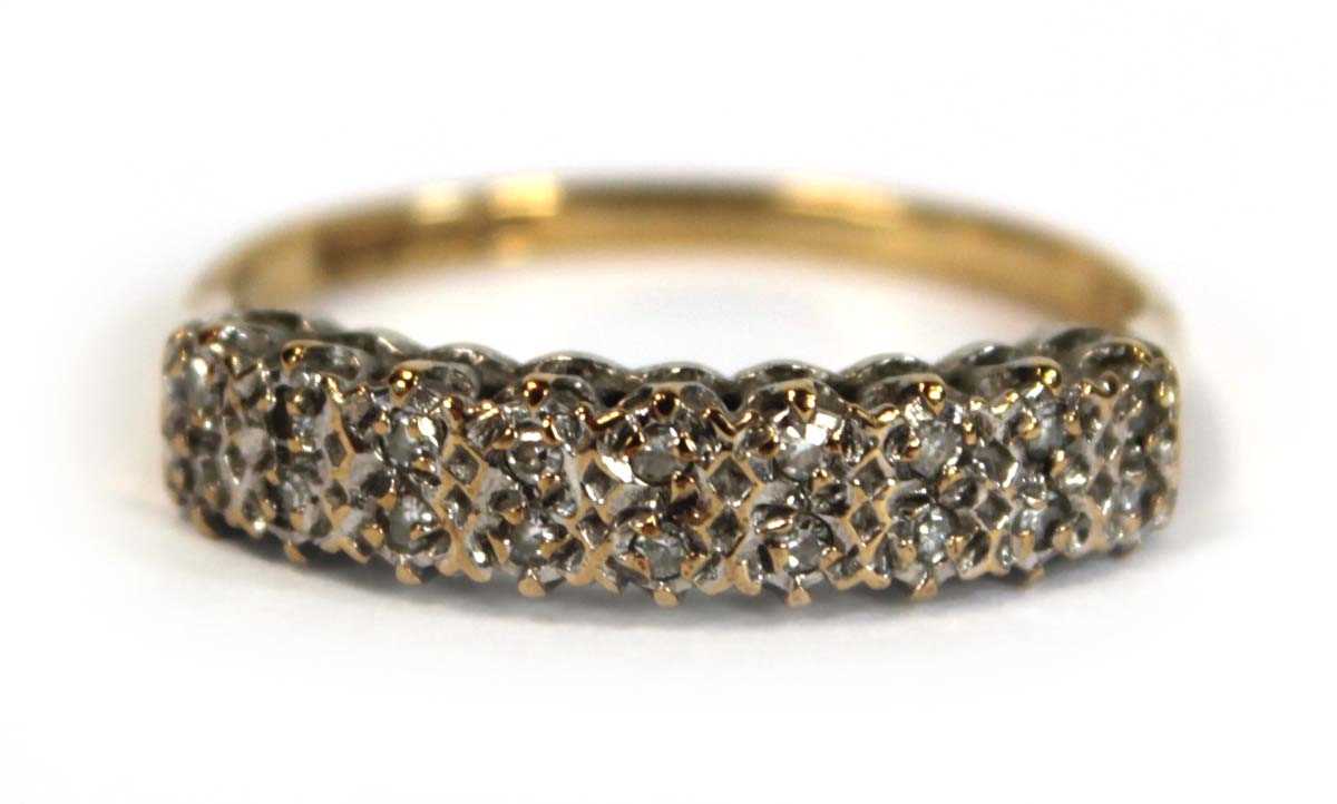 Lot 655 - A 9ct yellow gold ring set two rows of small...