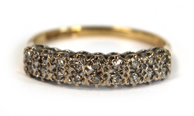 Lot 655 - A 9ct yellow gold ring set two rows of small...