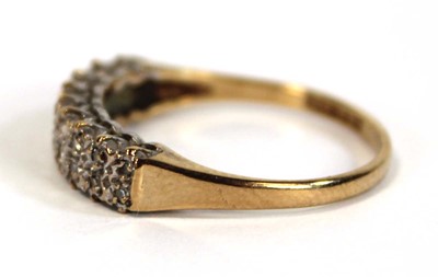 Lot 655 - A 9ct yellow gold ring set two rows of small...