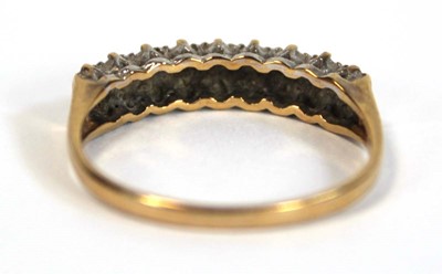 Lot 655 - A 9ct yellow gold ring set two rows of small...