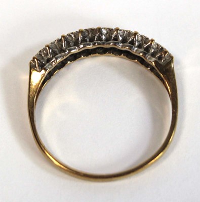 Lot 655 - A 9ct yellow gold ring set two rows of small...