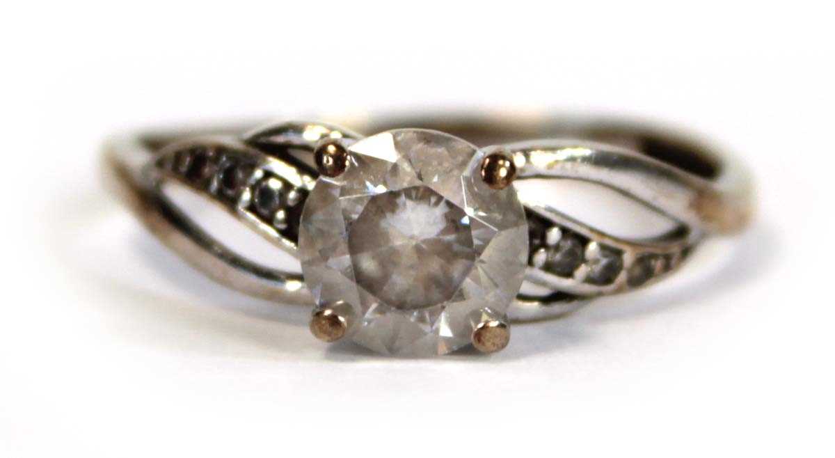 Lot 656 - A 9ct white gold ring set white stone in a...