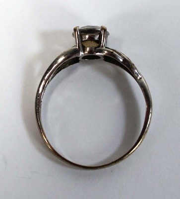 Lot 656 - A 9ct white gold ring set white stone in a...