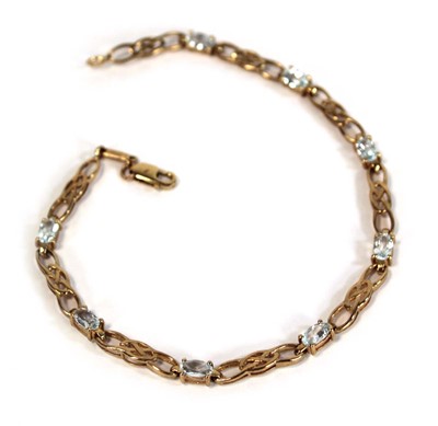 Lot 660 - A 9ct yellow gold tennis bracelet set pale...