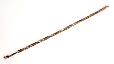 Lot 660 - A 9ct yellow gold tennis bracelet set pale...