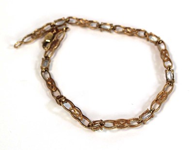Lot 660 - A 9ct yellow gold tennis bracelet set pale...