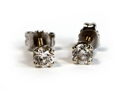 Lot 680 - A pair of yellow metal screw back ear studs,...