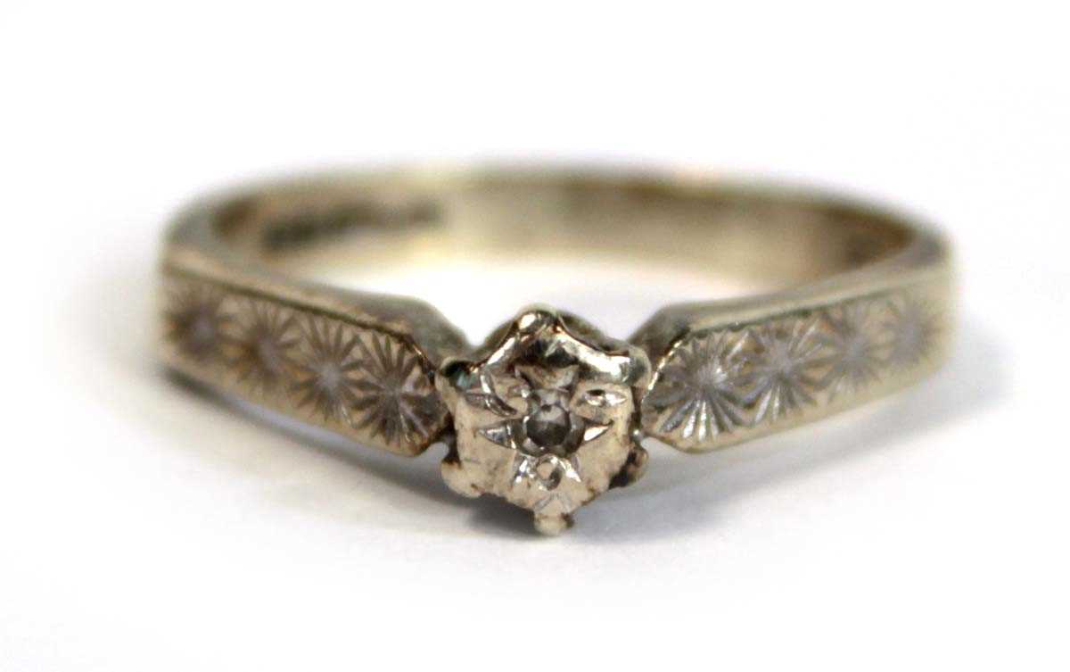 Lot 685 - A 9ct white gold ring set small diamond in an...