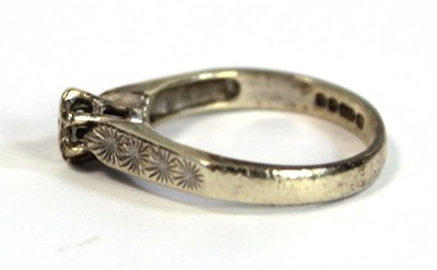Lot 685 - A 9ct white gold ring set small diamond in an...