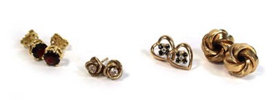 Lot 689 - A pair of 18ct yellow gold ear studs, each set...