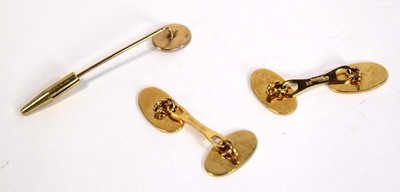Lot 691 - A pair of 9ct yellow gold oval cufflinks and a...