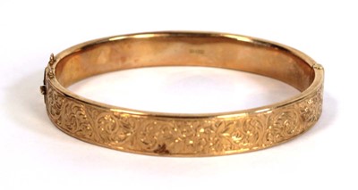 Lot 692 - A 15ct yellow gold florally engraved hinged...