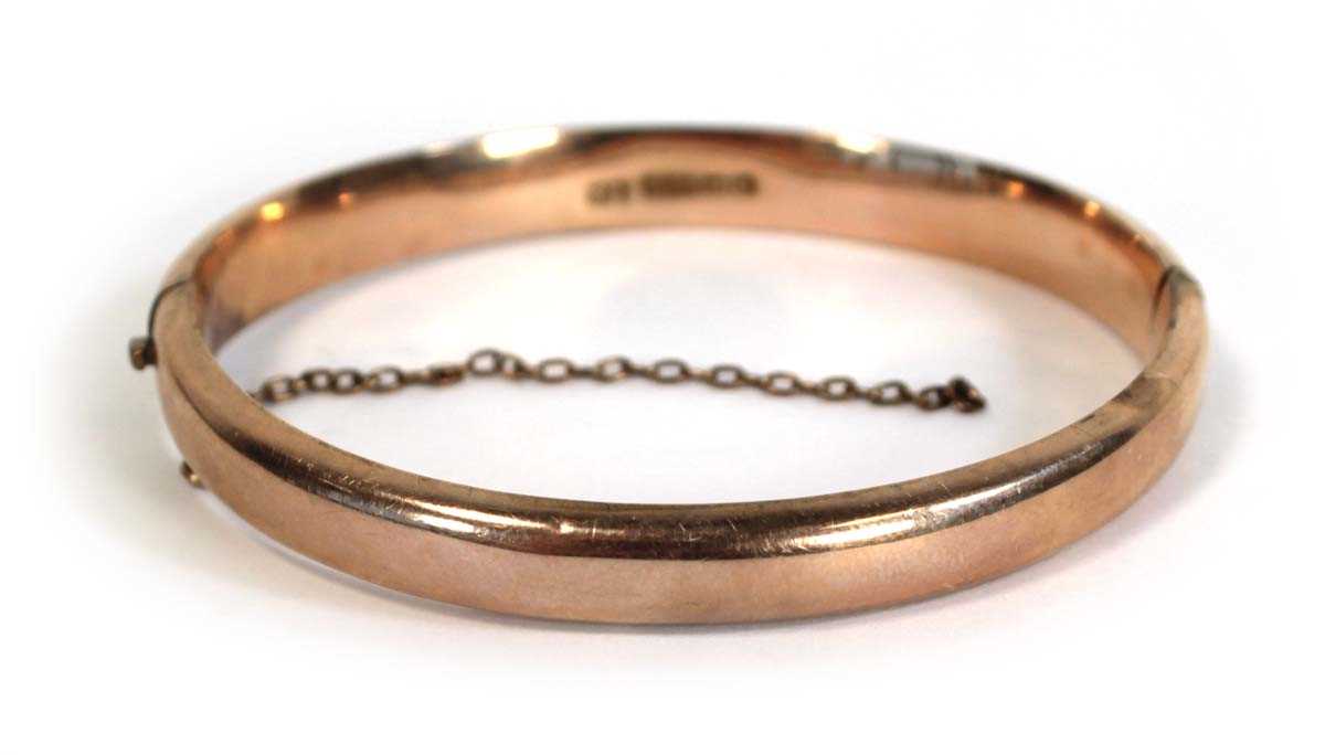 Lot 693 - A 9ct rose gold hinged bracelet, Birmingham...