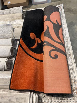 Lot 1829 - Supreme Rugs black and orange area rug. Size...