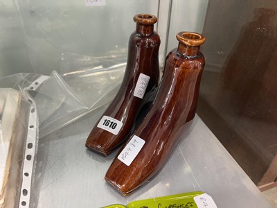 Lot 1610 - Pair of brown ceramic boot bottles
