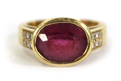 Lot 730 - A yellow metal ring set oval pink stone within...