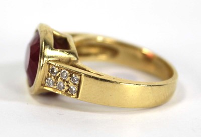 Lot 730 - A yellow metal ring set oval pink stone within...
