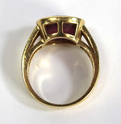Lot 730 - A yellow metal ring set oval pink stone within...