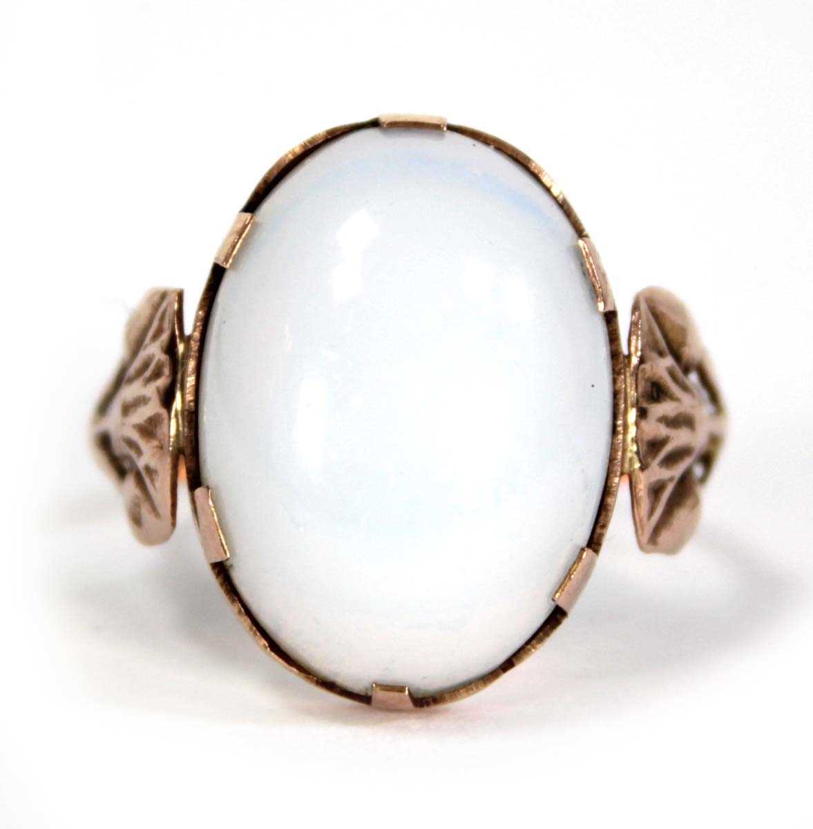 Lot 733 - An Egyptian rose gold ring set oval opaline...
