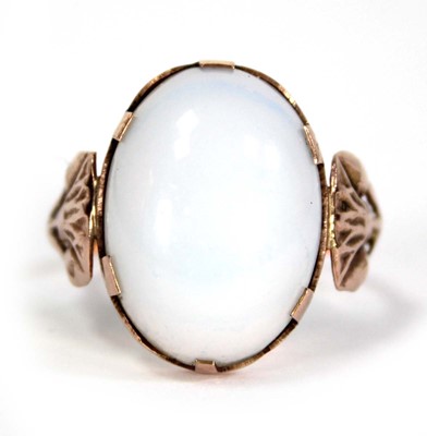Lot 733 - An Egyptian rose gold ring set oval opaline...