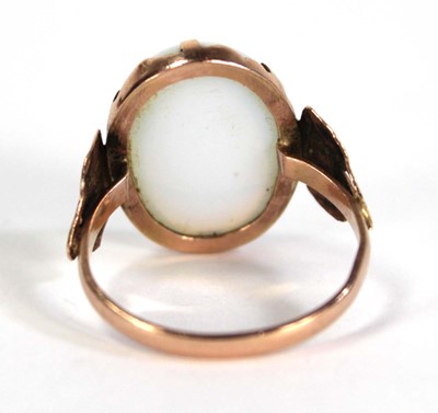 Lot 733 - An Egyptian rose gold ring set oval opaline...