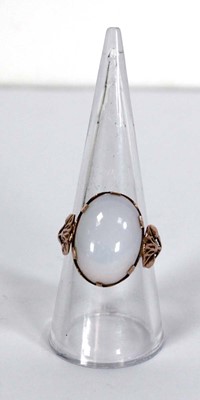 Lot 733 - An Egyptian rose gold ring set oval opaline...