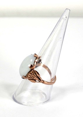 Lot 733 - An Egyptian rose gold ring set oval opaline...