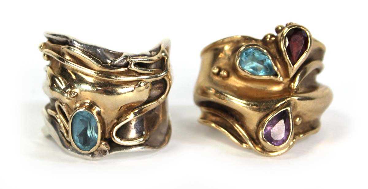 Lot 734 - A yellow metal ring of abstract design set...