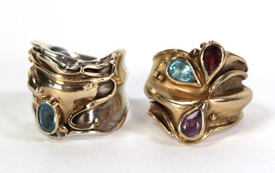 Lot 734 - A yellow metal ring of abstract design set...