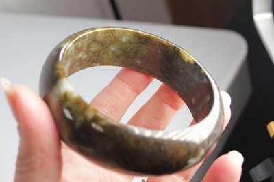Lot 740 - Two jade-type bangles, internal d. 6.7 cm and...