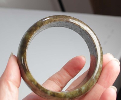 Lot 740 - Two jade-type bangles, internal d. 6.7 cm and...