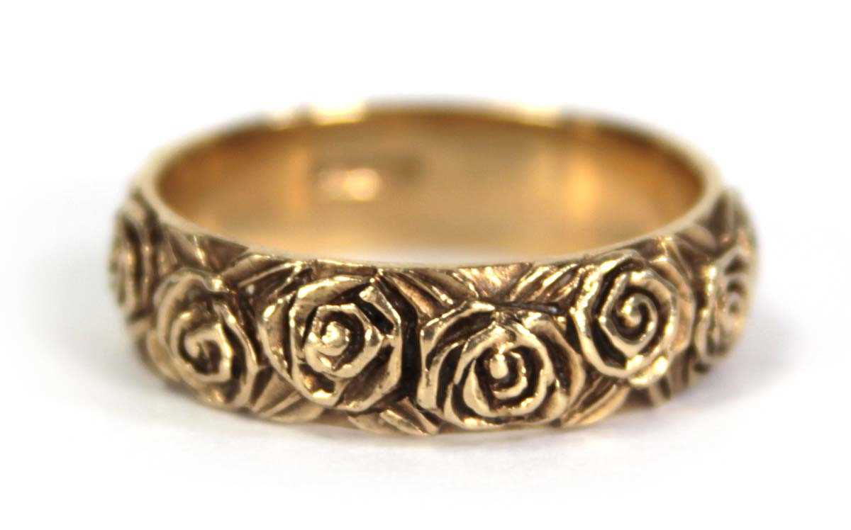 Lot 747 - A 9ct yellow gold band ring partially...