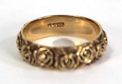 Lot 747 - A 9ct yellow gold band ring partially...