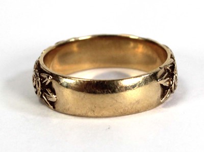 Lot 747 - A 9ct yellow gold band ring partially...