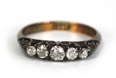Lot 748 - An 18ct yellow gold ring set five small...