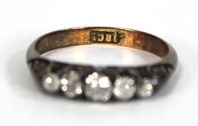 Lot 748 - An 18ct yellow gold ring set five small...