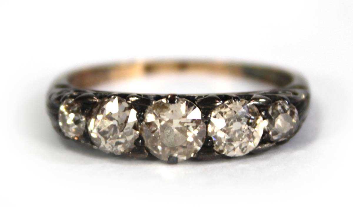 Lot 749 - An 18ct yellow gold ring set five small...